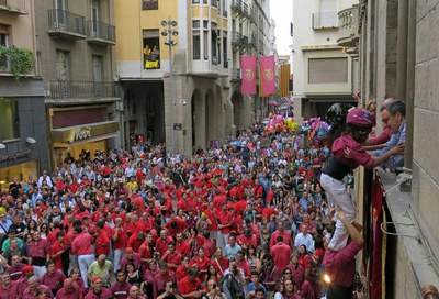 La Diada Castellera ha acabat, com és tradició, amb l'alcalde agafant l'enxaneta per la finestra de la Paeria, en una plaça plena a vessar.