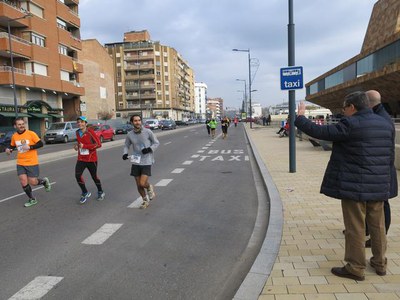 L'alcalde Ros, animant els participants de la cursa al seu pas per la Llotja.