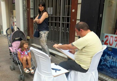 Caricaturistes dibuixant vianants per l'Eix.