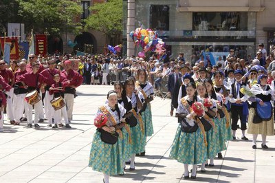 Les pubilles, les primeres a fer l'ofrena floral a la plaça Sant Joan.