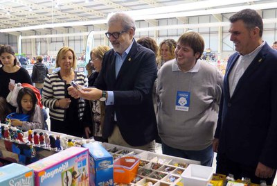 L'alcalde contempla la figura del 'caganer' nadalenc de playmobil, la figura estrella del saló.