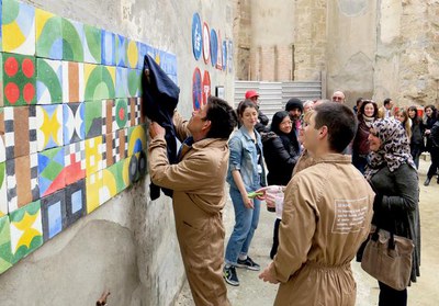 El mural, de rajoles hidràuliques, és el resultat del projecte “Ex nunc. Què necessita una ciutat per ser justa?”, dissenyat per Adriana Comparetto.