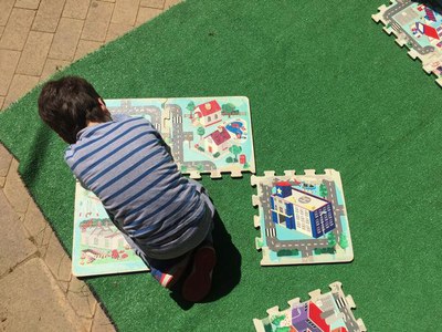 Un infant, jugant amb una activitat del Parc de Somriures..