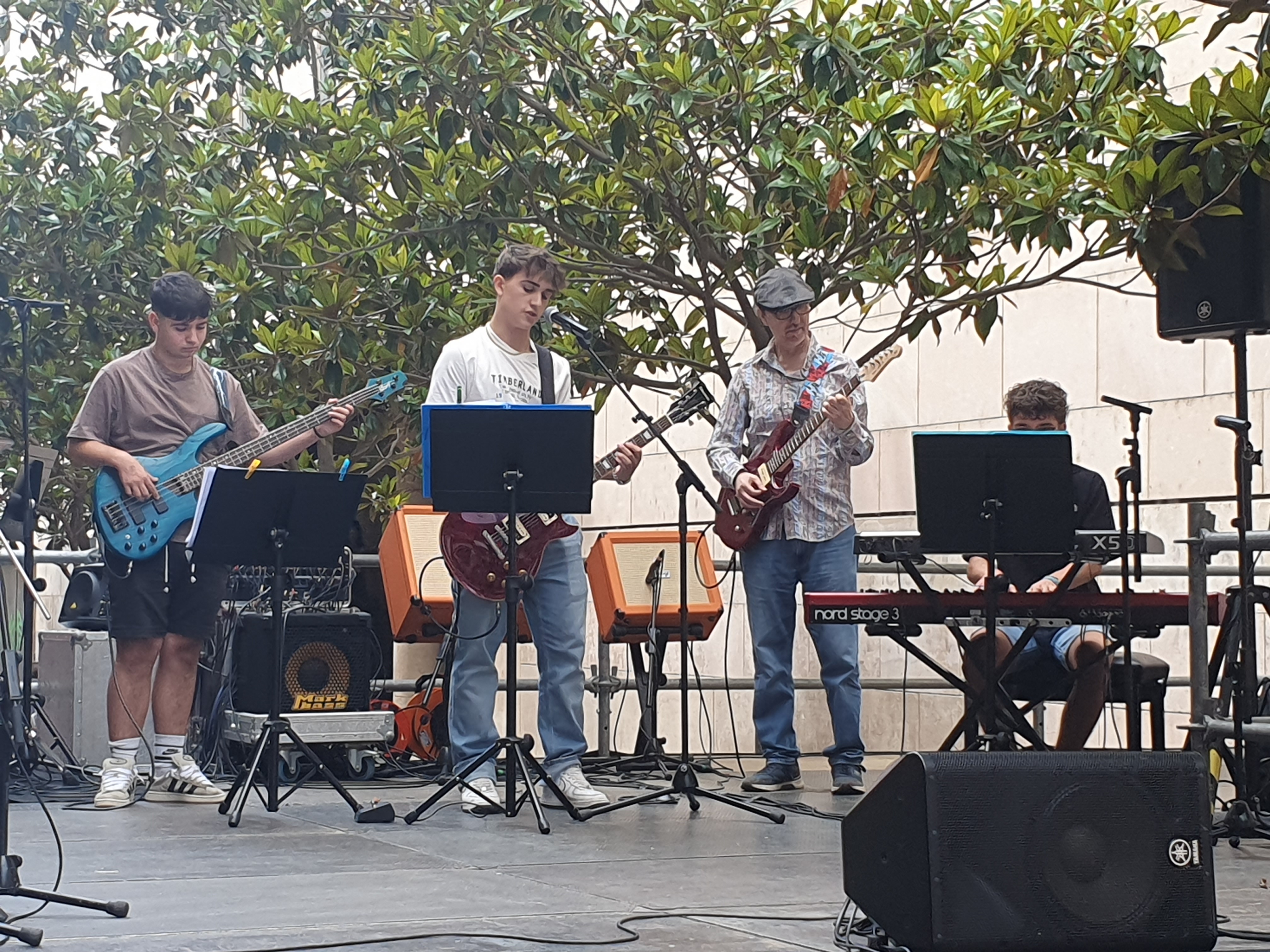 Tres joves tocant música moderna a l'escenari del C/Pi i Maragall