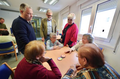 Usuàries del centre de dia, amb un dels jocs que porten els ludotecaris, sota la mirada de Larrosa i Valls.