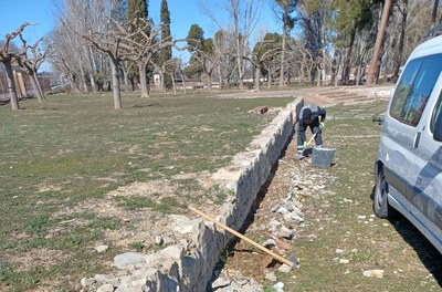 Un membre de la brigada Lleida Ciutat Amable fent la neteja i arranjament a la zona de l’antic càmping.