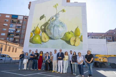 El alcalde, Fèlix Larrosa, el teniente de alcalde Carlos Enjuanes y la concejala Pilar Bosch con los artistas y directores del festival y el vecindario de Pardinyes bajo uno de los murales.
